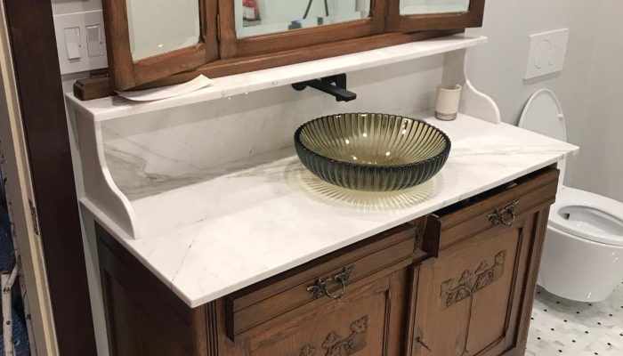 Vintage vanity mirror and vessel sink after Marble Heritage Vanity Restoration