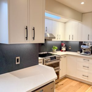 Elegant kitchen renovation featuring seamless Quartz surfaces and matte fixtures.