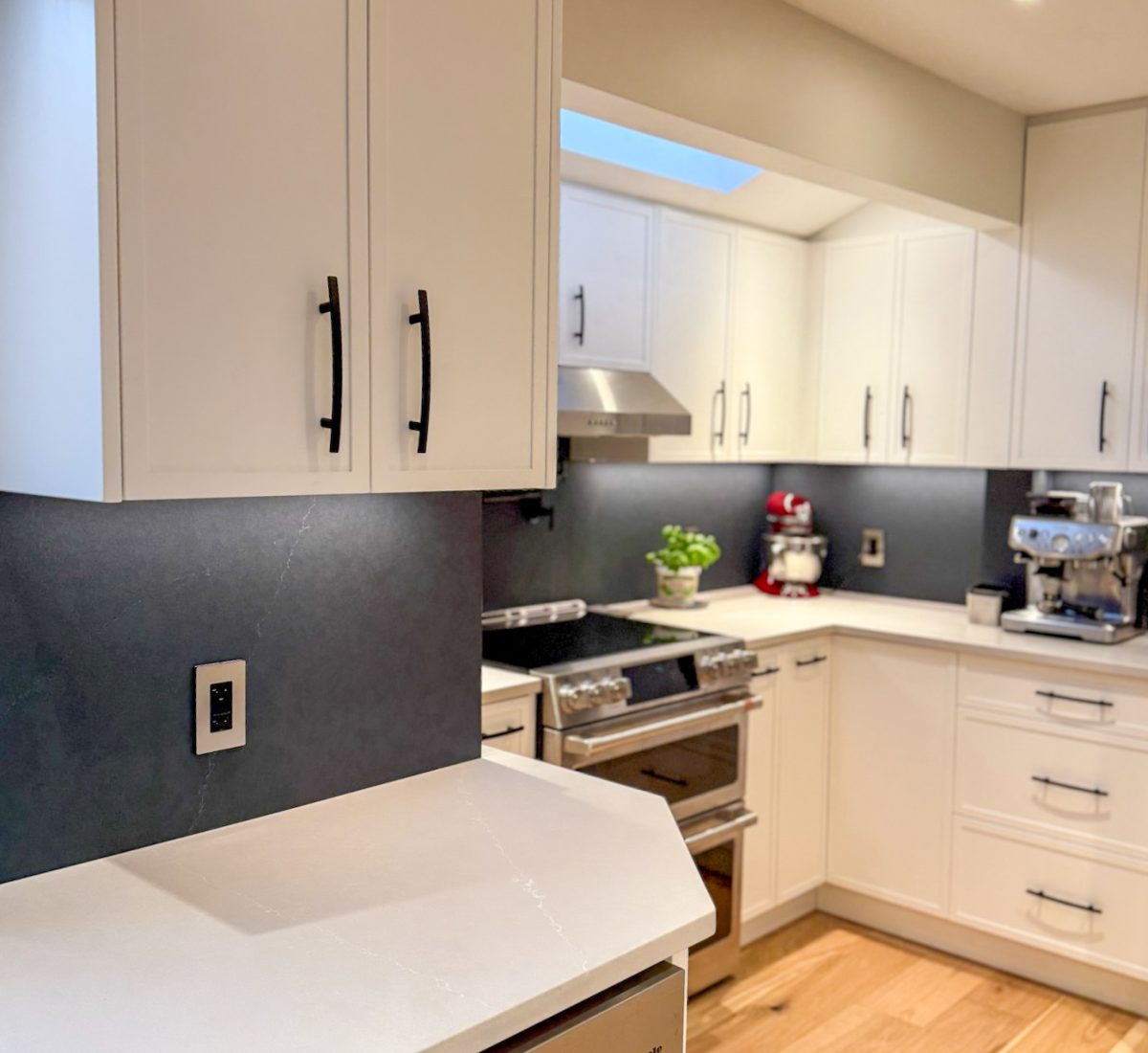 Elegant kitchen renovation featuring seamless Quartz surfaces and matte fixtures.